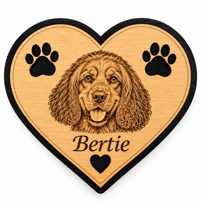 Personalised wooden heart fridge magnet featuring an engraved dog's face, paw prints and the name Bertie, with natural wood finish and black border.