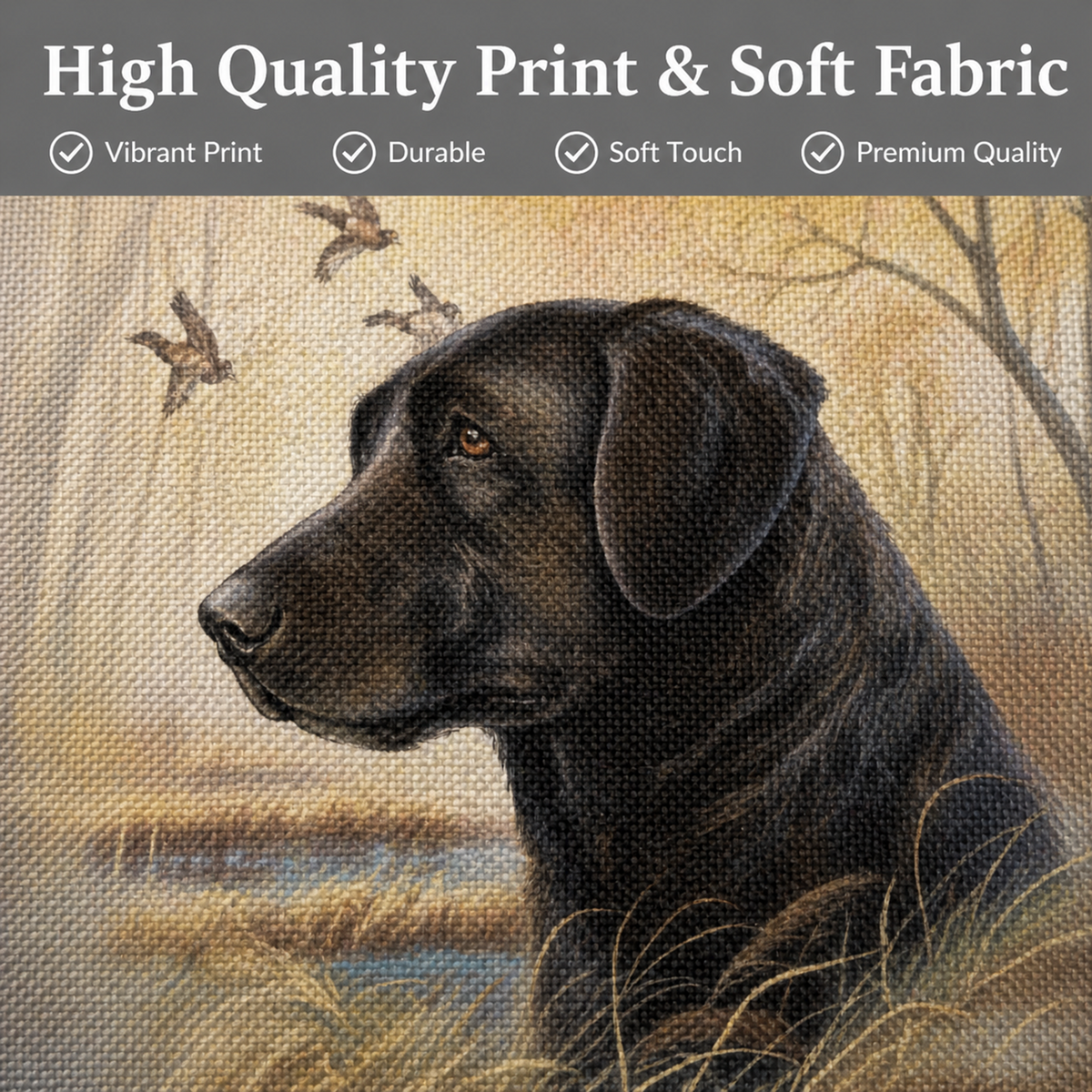 A square fabric close up of a cushion cover featuring a black Labrador Retriever dog in profile against a warm beige and brown outdoor scene with birds and reeds. A dark banner across the top reads 'High Quality Print & Soft Fabric' with feature checkmarks.