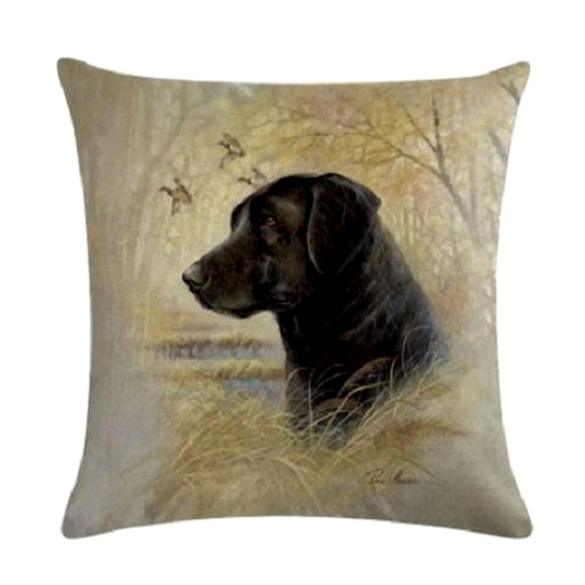 Decorative cushion cover with a black Labrador dog in a natural setting design.