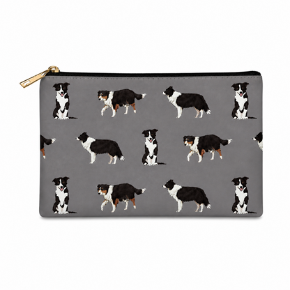 A grey zipped cosmetic bag featuring a repeating pattern of black and white Border Collie dogs, with a gold zipper pull.