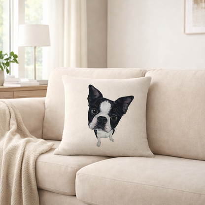 A square cushion cover  featuring a printed black and white Boston Terrier dog face, resting on a beige fabric sofa in a bright, modern living room.