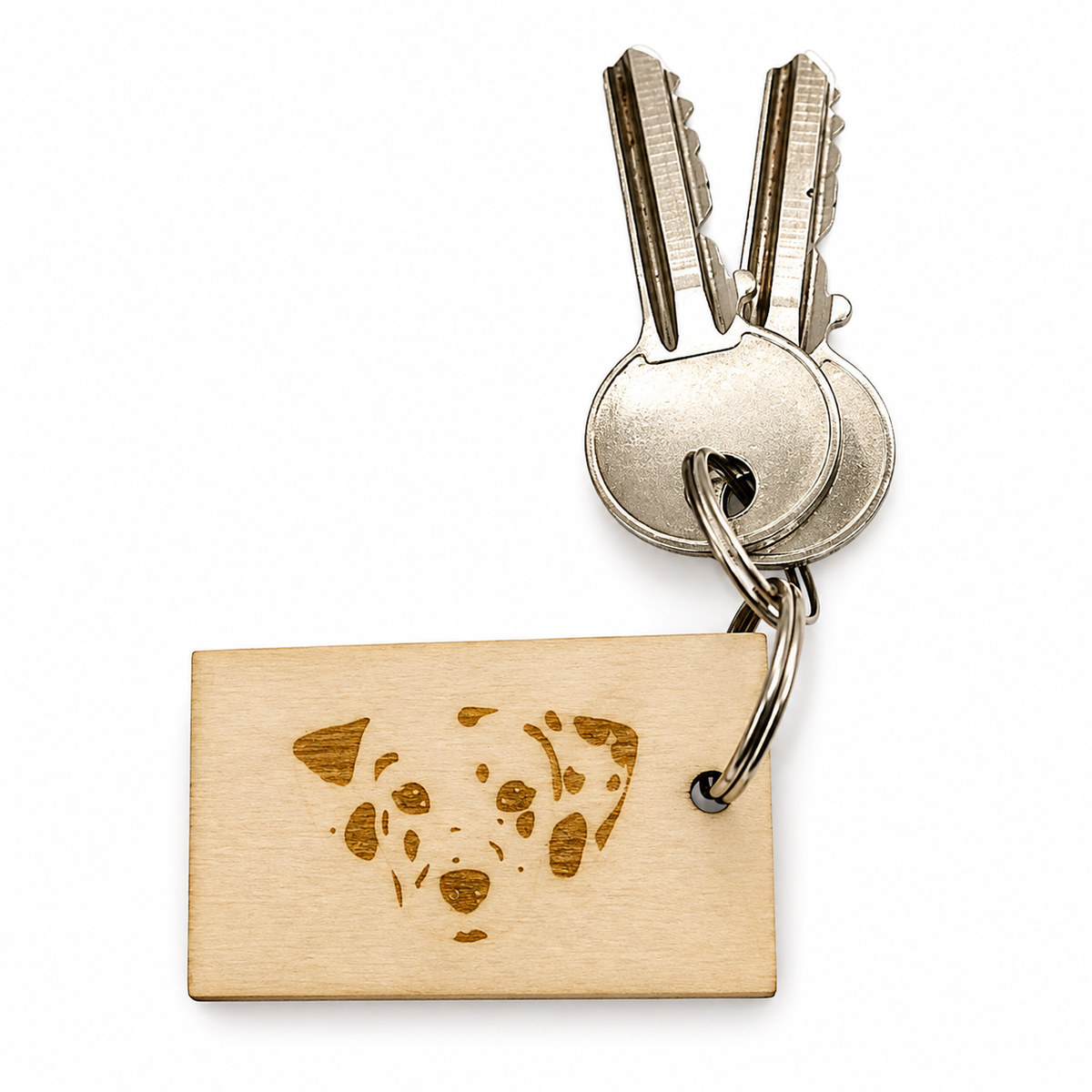 A rectangular wooden key tag with an engraved Dalmatian dog face, attached to a metal keyring with two keys, on a white background.