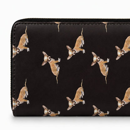 A black zip-around wallet featuring a repeating pattern of small brown and white Chihuahua dogs in a playful pose, shown against a plain white background.