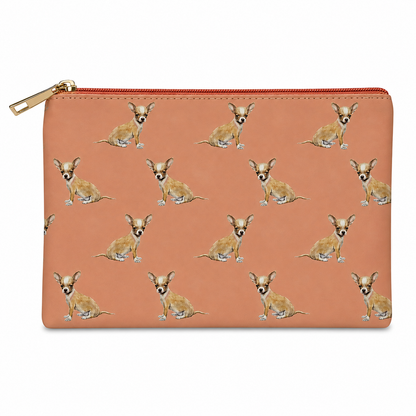A rectangular zip pouch in a warm pink colour, featuring an all-over repeating pattern of small tan and white Chihuahua dog illustrations. The pouch has a gold-tone zipper pull and is photographed flat against a solid white background.
