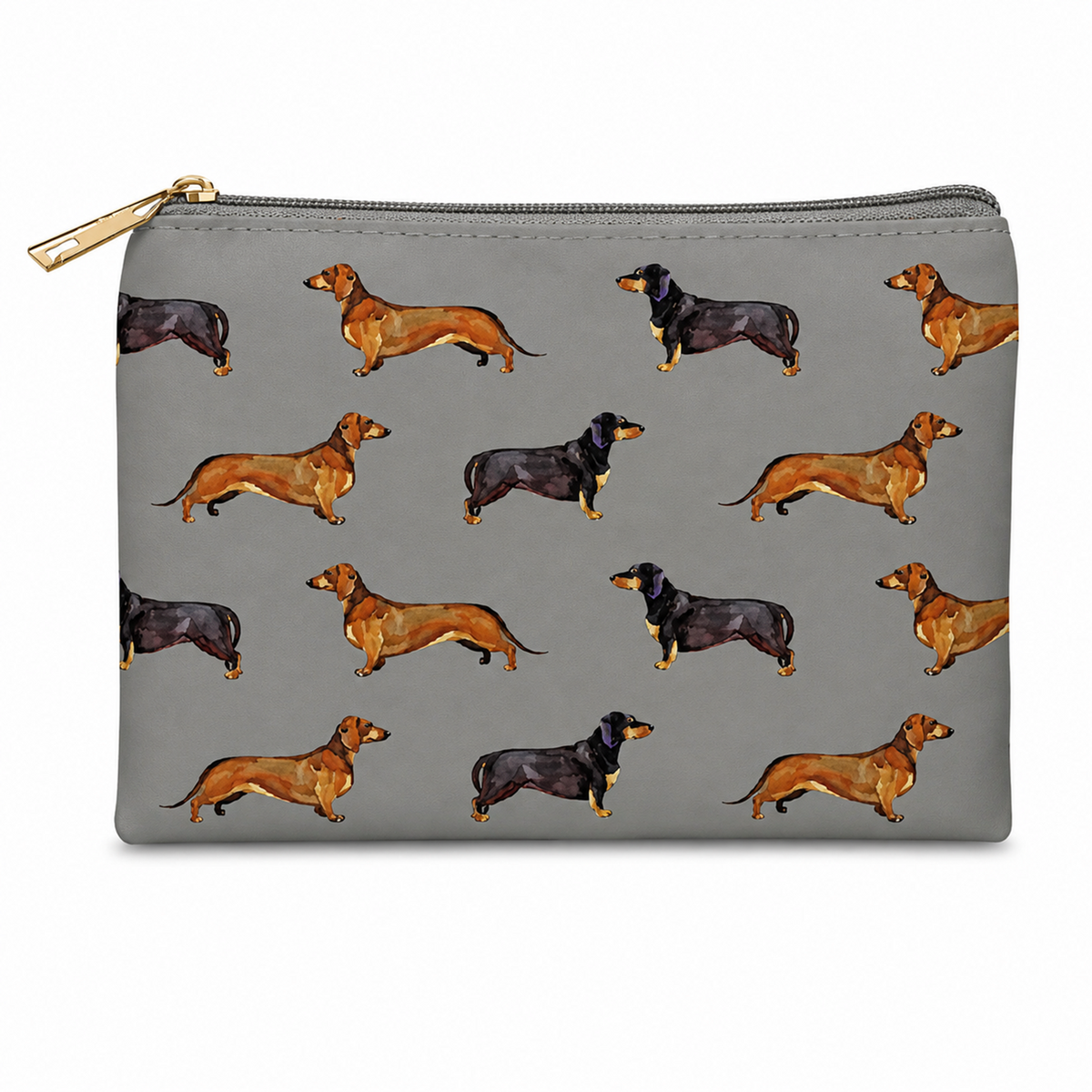 A grey zipped cosmetic bag featuring an all-over print of dachshund dogs in tan and black, with a gold zipper pull, shown on a plain white background.