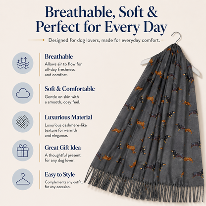 A dark grey dog scarf with a pattern of dachshund sausage dogs and tassels, hanging on a hanger against a light beige background with product feature text and icons.
