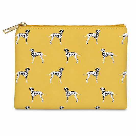 A mustard zippered cosmetic bag featuring an all-over print of Dalmatian dogs, with a gold zipper and pull tab, shown on a plain white background.