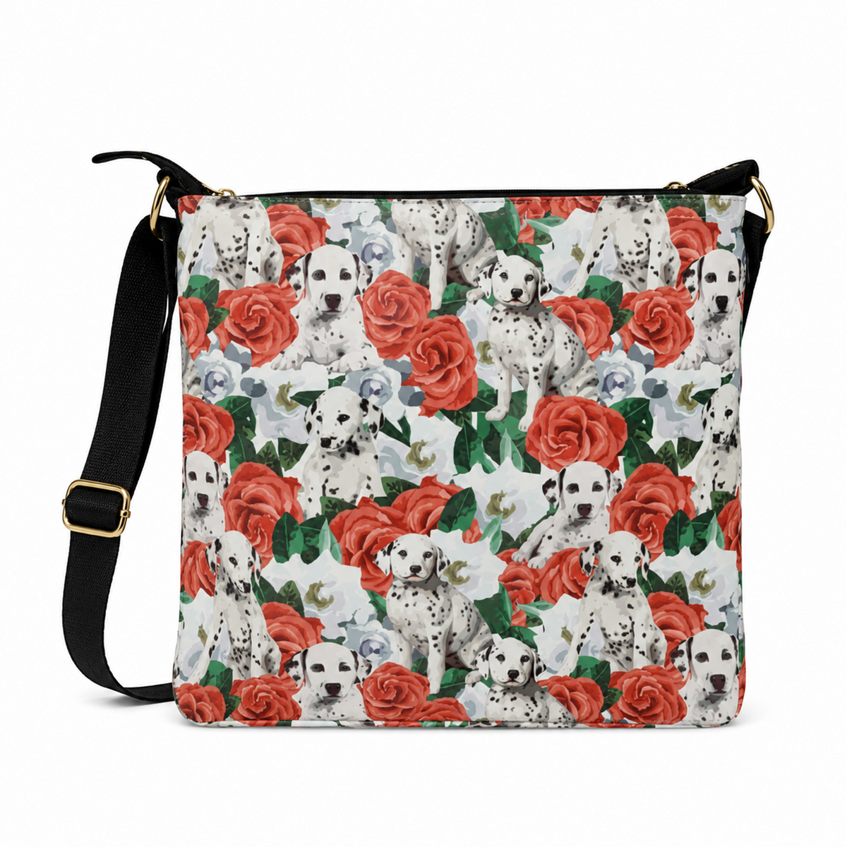 A square crossbody bag featuring a repeating pattern of Dalmatian dogs and red roses on a white background, with a black shoulder strap and gold-tone hardware.