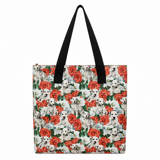A tote bag featuring an all-over pattern of Dalmatian dogs and red roses on a white background, with black shoulder straps.