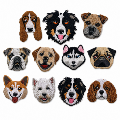 A set of eleven embroidered dog head patches arranged in a 3x4 grid on a plain white background. The patches depict various real dog breeds, including breeds like the Basset Hound, Border Collie, Pug, and Cavalier King Charles Spaniel, in a traditional tufted needlepoint style.