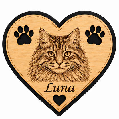 Personalised wooden heart fridge magnet featuring an engraved cat's face, paw prints and the name Luna, with natural wood finish and black border.