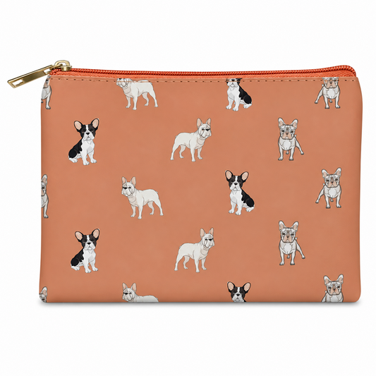 A zipped cosmetic bag with a pink background and an all-over print of French Bulldog illustrations, featuring a gold zipper pull.