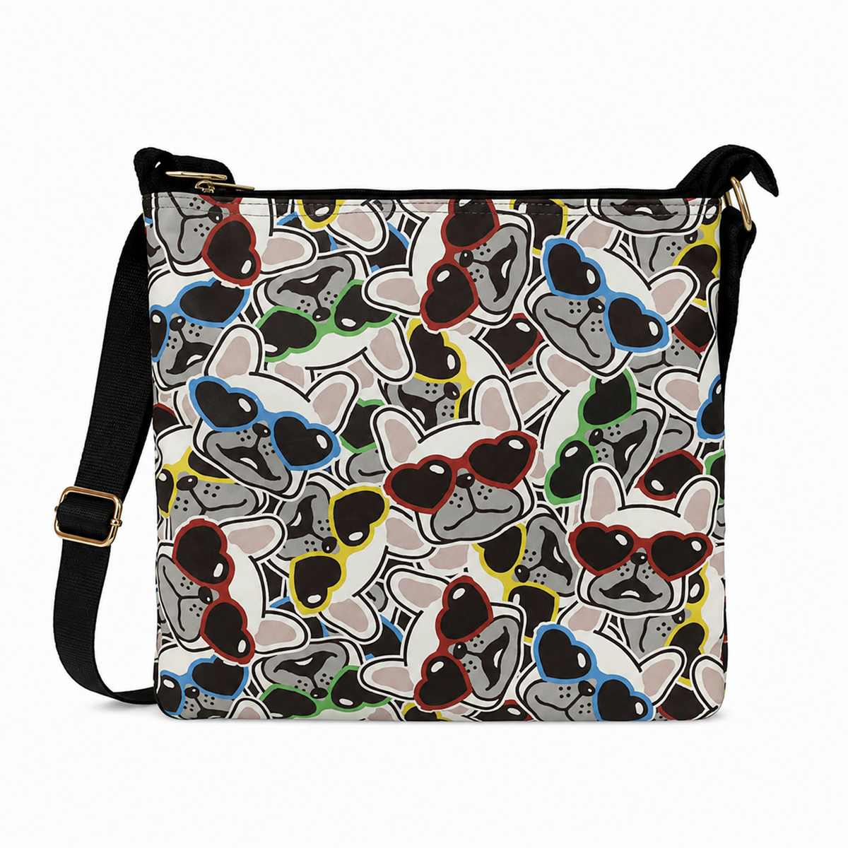A crossbody bag with a white background and an all-over pattern of cartoon French bulldogs wearing colorful sunglasses. The bag has a black shoulder strap with a gold buckle and gold zipper hardware.