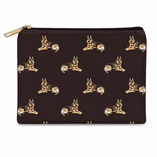 A black zipped cosmetic bag featuring an all-over repeating pattern of German Shepherd dogs in tan and black, with a gold-tone zipper pull.