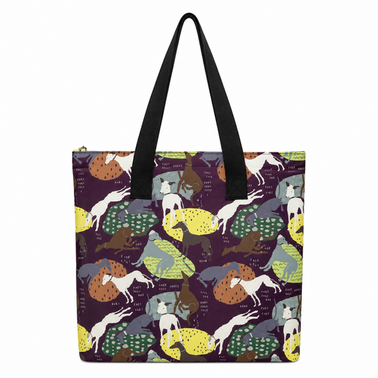 A tote bag with black shoulder straps and a dark purple background covered in a repeating pattern of Greyhound Whippet dogs in white, grey, brown, and yellow. The bag is photographed against a plain white background.