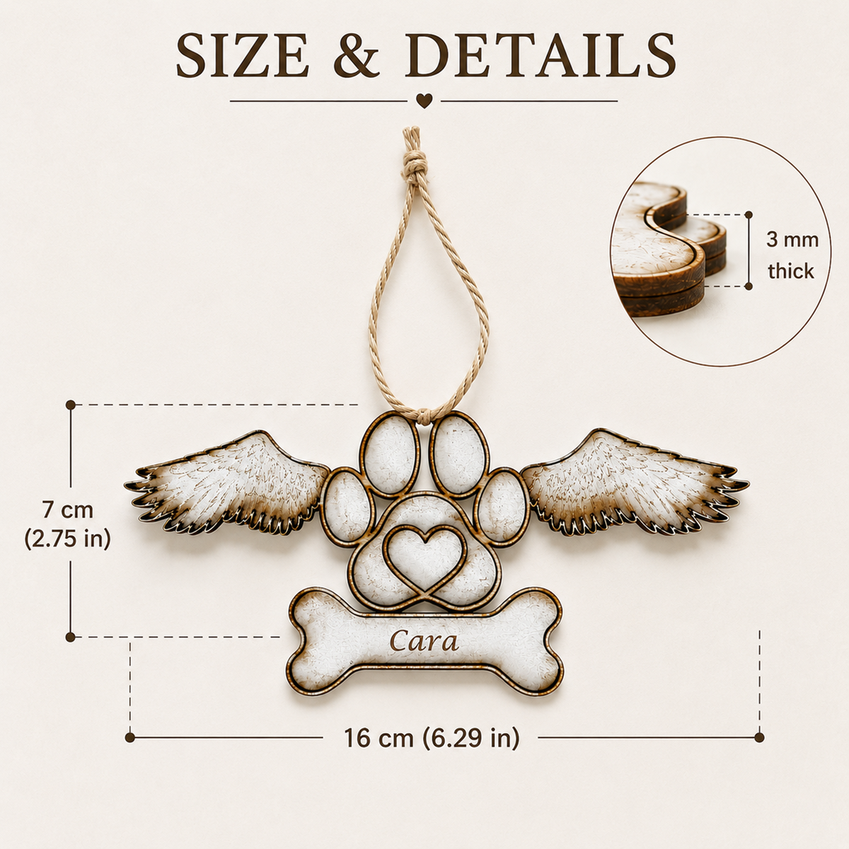 Personalised pet memorial ornament with wings and paw print design, showing dimensions of 16 cm by 7 cm and a detail inset of 3 mm thickness, on a light beige background.