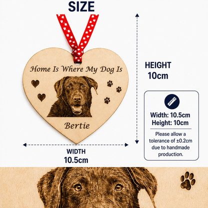 Personalized wooden heart dog memorial plaque with engraved dog portrait, paw prints, and the text 'Home Is Where My Dog Is' and 'Bertie', shown with size annotations: 10cm height and 10.5cm width, plus a red-and-white polka dot hanging ribbon.