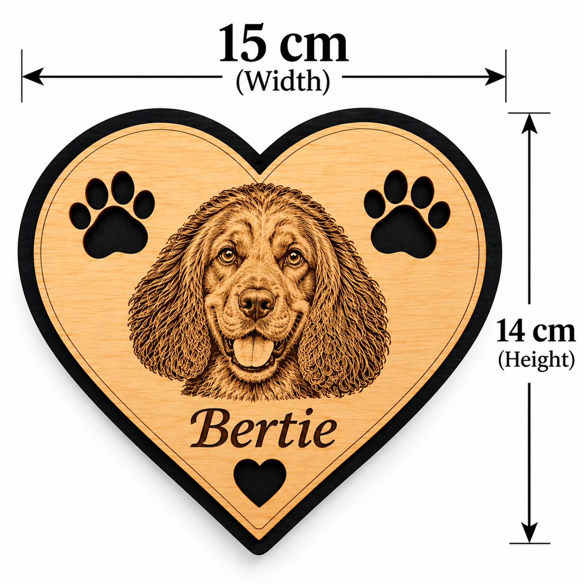 Heart-shaped wooden plaque with a engraved dog portrait, two paw prints, and the name 'Bertie' on a light wood surface with black border, shown with dimension arrows labeled 15 cm width and 14 cm height.