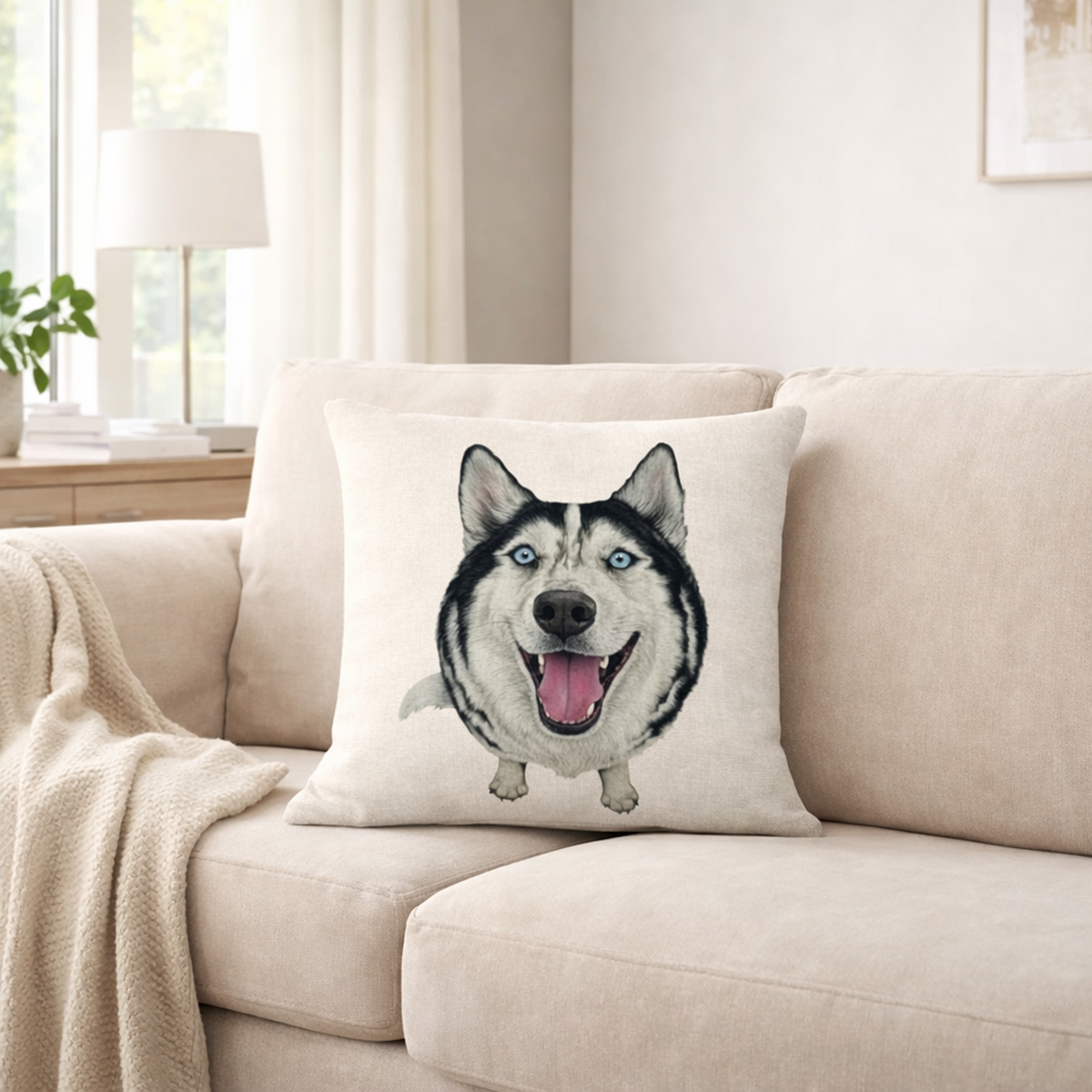 A square cushion cover featuring a printed illustration of a husky dog face, resting on a beige fabric sofa in a bright, modern living room.