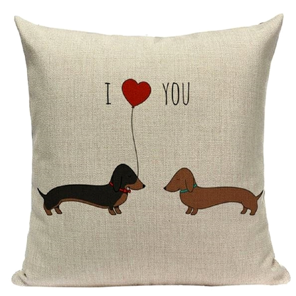 Decorative pillow with two dachshunds holding a heart-shaped balloon and 'I love you' text.