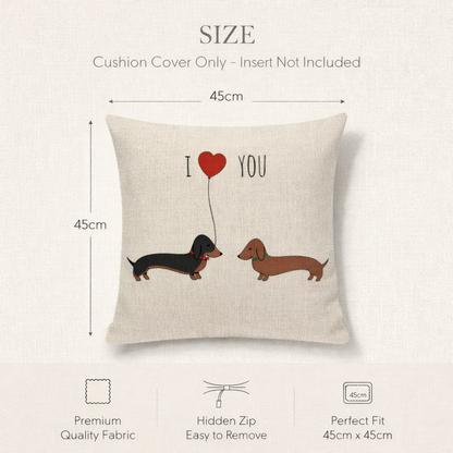 A size diagram for a square cushion cover on a light beige textured background. The cushion cover illustration shows two dachshunds facing each other with a red heart-shaped balloon and the text 'I Love YOU'.