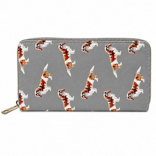 A grey zip-around wallet with a repeating pattern of brown and white King Charles Cavalier Spaniel dog illustrations, shown on a plain white background.