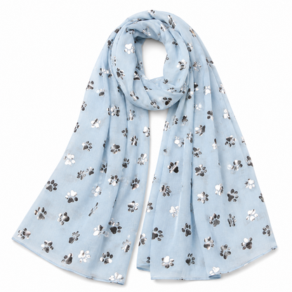 A light blue scarf with an all-over pattern of small paw prints in silver, draped on a plain white background.