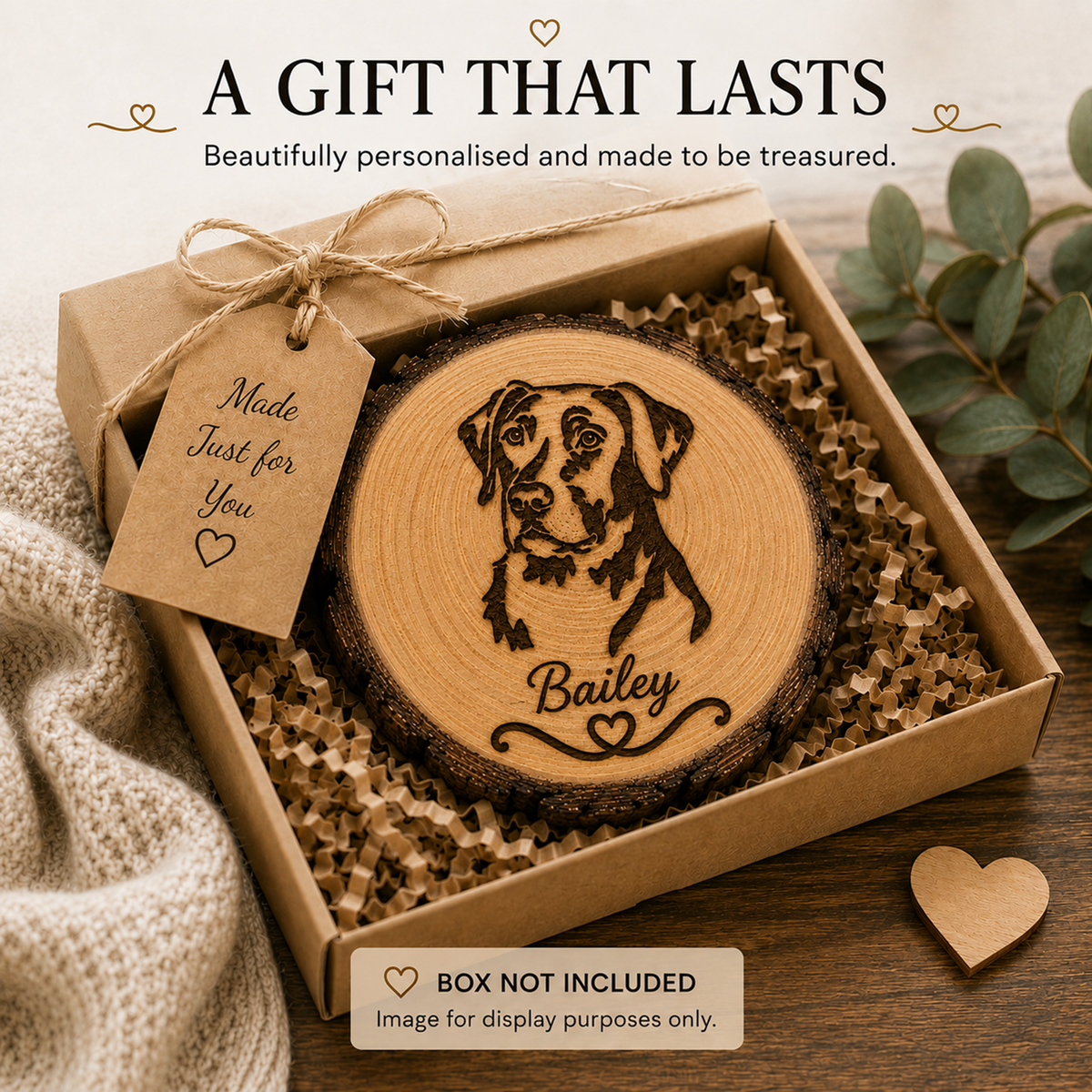 A round laser-engraved wood slice coaster featuring a dog portrait and the name 'Bailey' in a kraft gift box filled with crinkle paper. A kraft tag reads 'Made Just for You'.