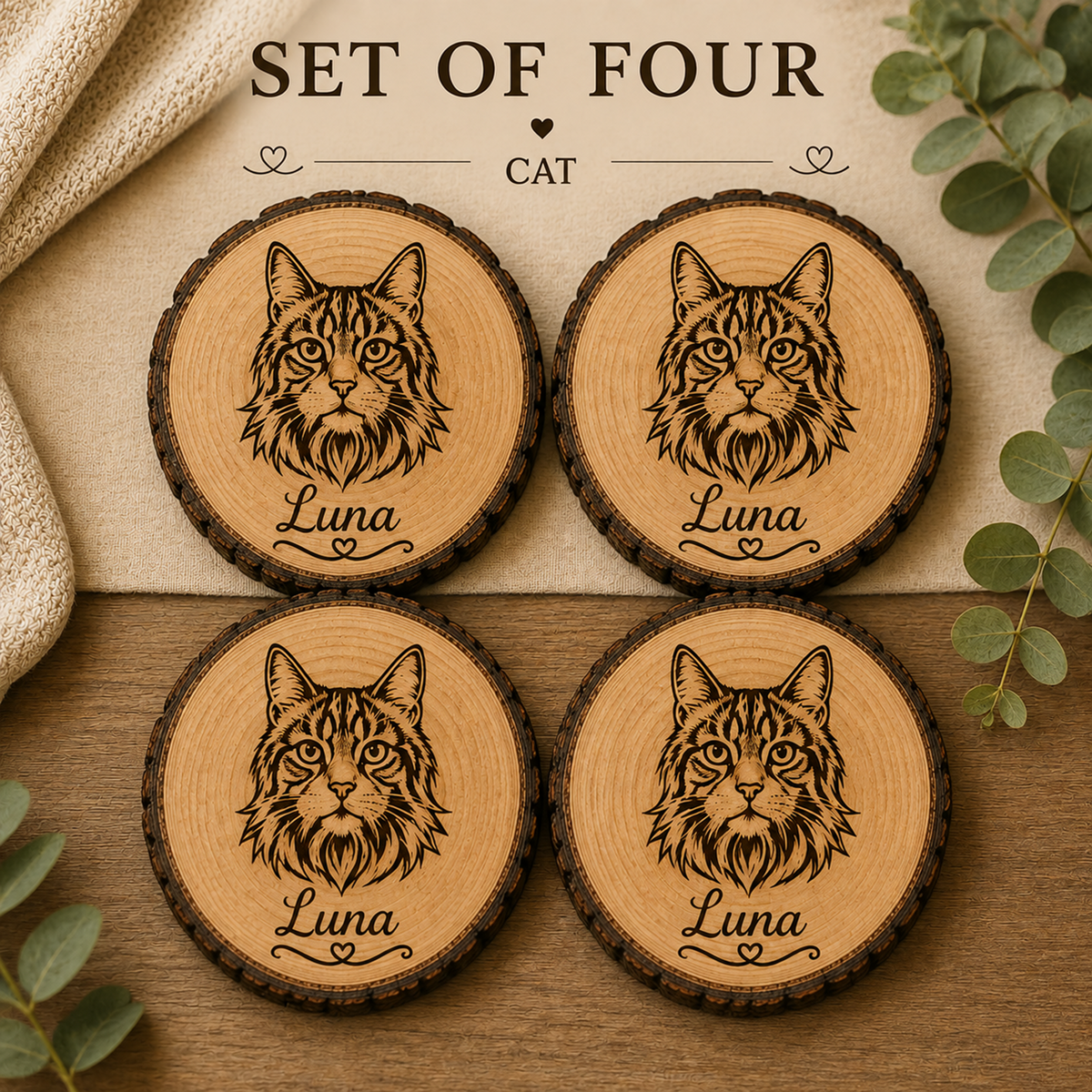 Set of four round wooden coasters featuring engraved cat portraits and the name 'Luna,' arranged on a tabletop with decorative leaves and fabric. Text at the top reads 'SET OF FOUR CAT'.