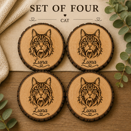 Set of four round wooden coasters featuring engraved cat portraits and the name 'Luna,' arranged on a tabletop with decorative leaves and fabric. Text at the top reads 'SET OF FOUR CAT'.