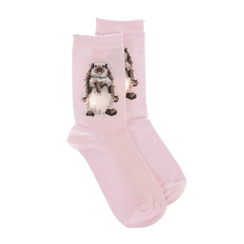 A pair of light pink baby socks with tiny white polka dots and a cute cartoon gerbil graphic on the front, shown against a plain white background.