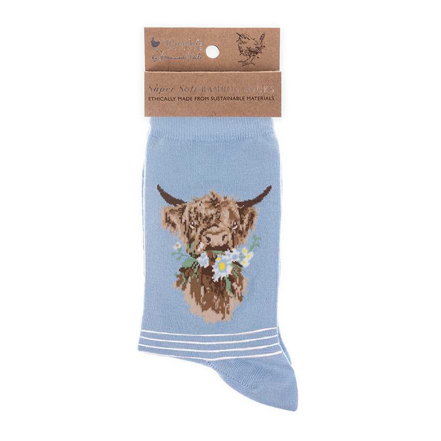 Blue sock with a highland cow design on a white background