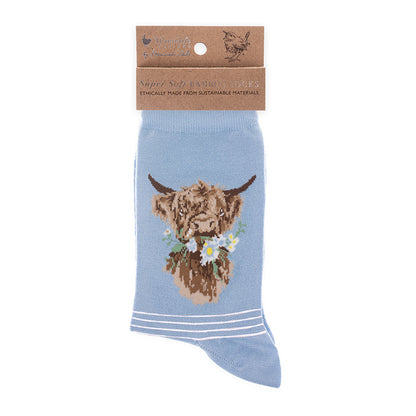 Blue sock with a highland cow design on a white background