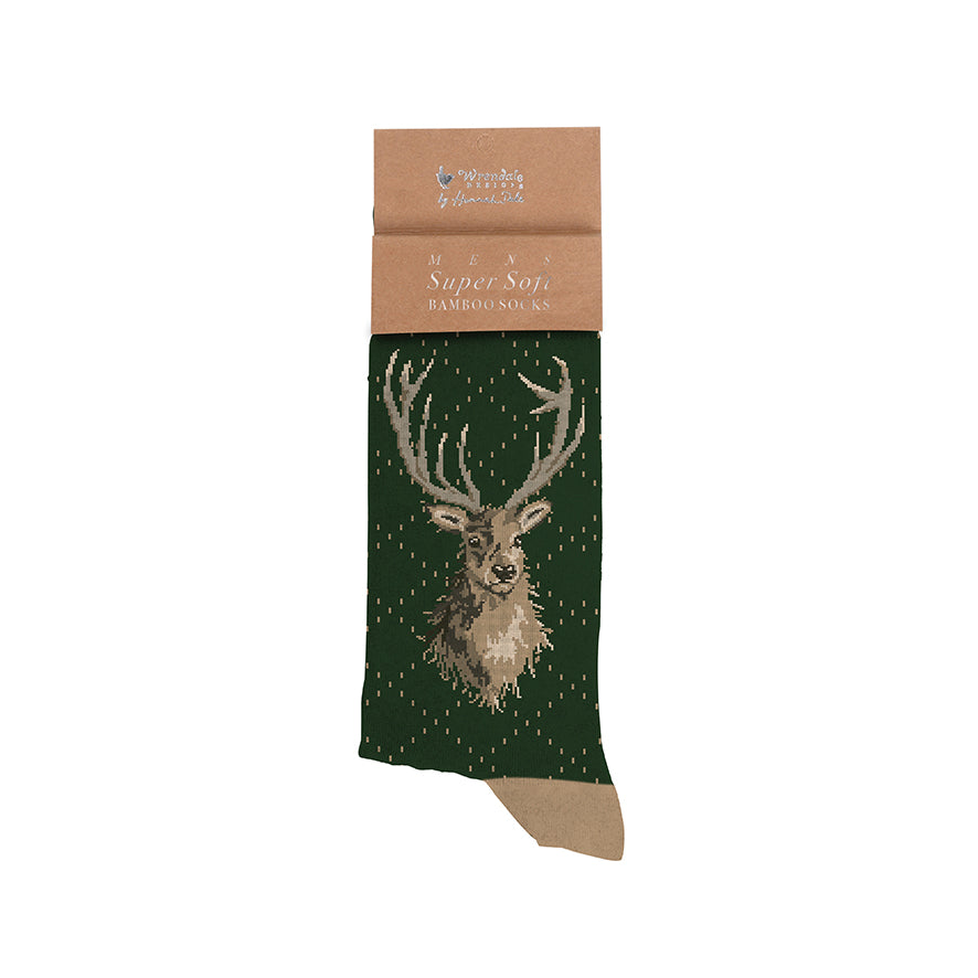 Green sock with deer design and brown packaging on a white background