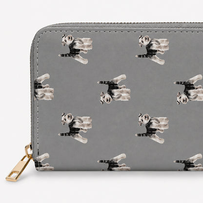 A grey zip-around wallet with a repeating print of Schnauzer  dogs in black, white, and grey, featuring a gold-tone zipper pull on a light grey background.