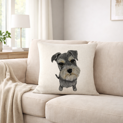 A square cream cushion cover  featuring a detailed illustration of a grey and white Schnauzer dog, resting on a beige fabric sofa in a bright, modern living room.