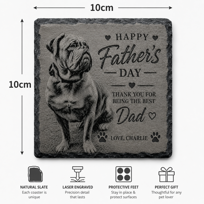A square natural slate coaster with laser-engraved text reading 'Happy Father's Day Thank You for Being the Best Dad Love, Charlie' and an engraved bulldog portrait. The image includes dimension markers showing 10cm by 10cm and feature icons for natural slate, laser engraving, protective feet, and gift presentation.