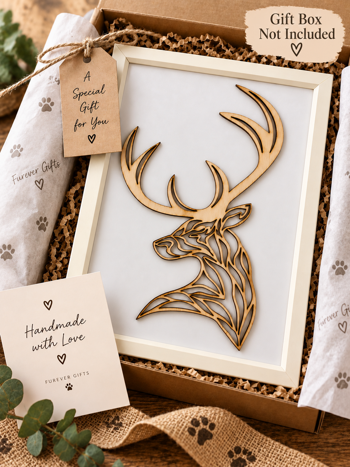 A laser-cut wooden stag head ornament displayed inside a gift box with tissue paper, a kraft gift tag reading 'A Special Gift for You,' and a card that says 'Handmade with Love.' A badge in the corner notes 'Gift Box Not Included.