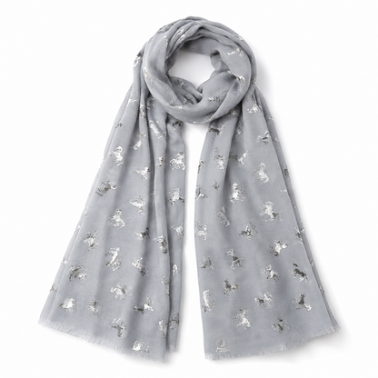 A light grey scarf with a repeating pattern of small metallic silver unicorns, draped in a loop on a white background.