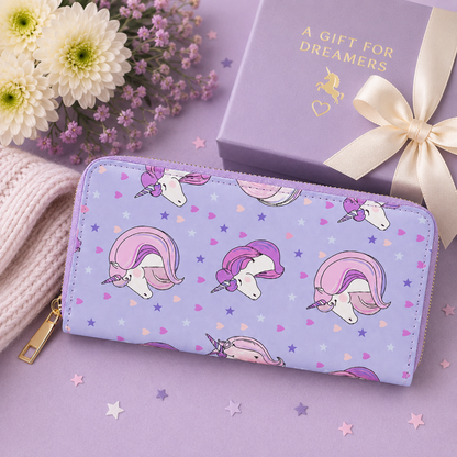 A pastel purple zip-around wallet with a unicorn print, styled on a lavender surface next to a matching gift box with a cream ribbon and flowers.