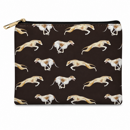 A zipped cosmetic bag with a black background and an all-over print of running greyhounds in white, tan, and brown. The pouch has a gold zipper pull and is photographed on a clean white background.