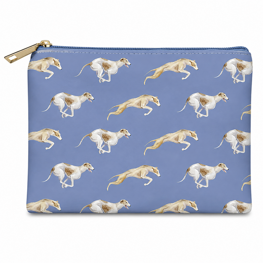 A rectangular zip cosmetic bag with a gold zipper and pull, featuring a repeating pattern of running greyhounds on a dusty blue background.