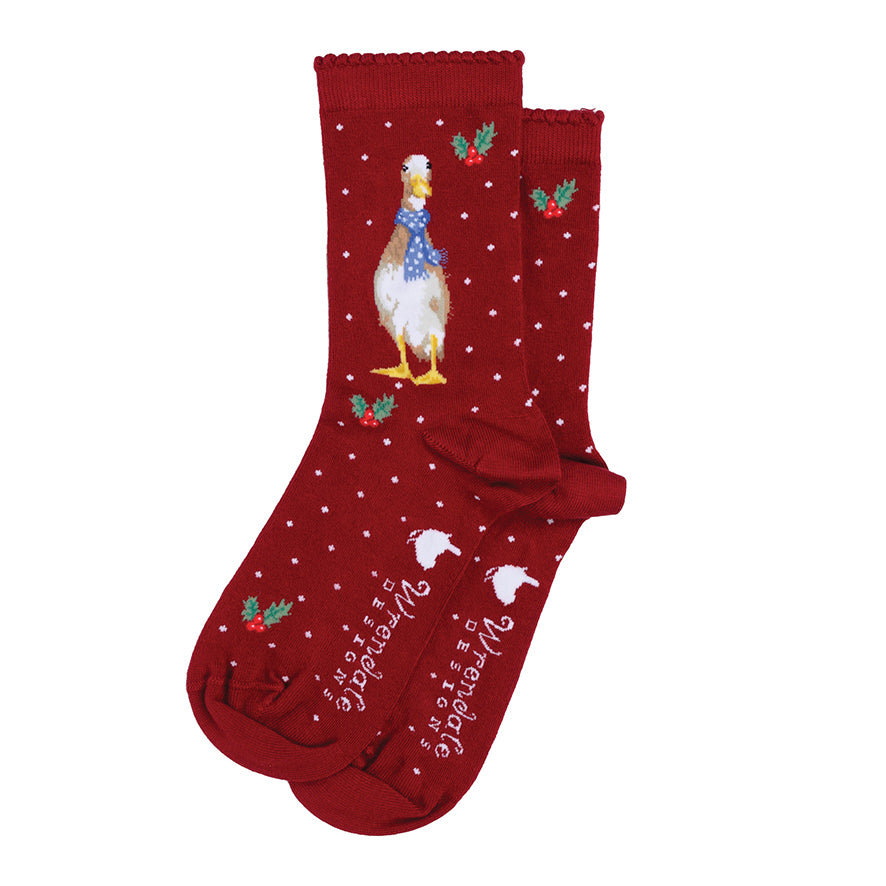 Red socks with a Christmas design featuring a reindeer and holly on a white background