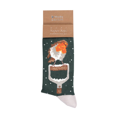 A single dark green Christmas-themed sock with a robin and shovel graphic, attached to a brown paper header card. The brand 'The Wren House of Fashion' is visible on the card.