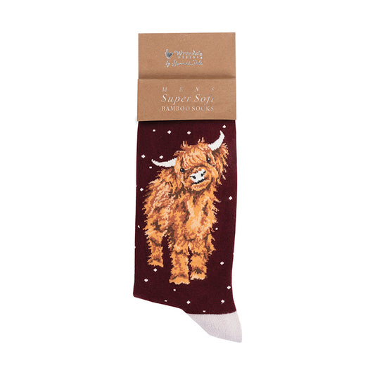 A single bamboo sock from Wrendale Designs, featuring a brown highland cow design on a dark maroon background with white stars, attached to a brown kraft paper header card.