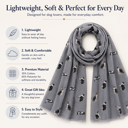 A light grey scarf with a repeating tri-coloured Border Collie dog print, styled in a loop on a cream background with promotional text listing its lightweight, soft, and comfortable qualities.