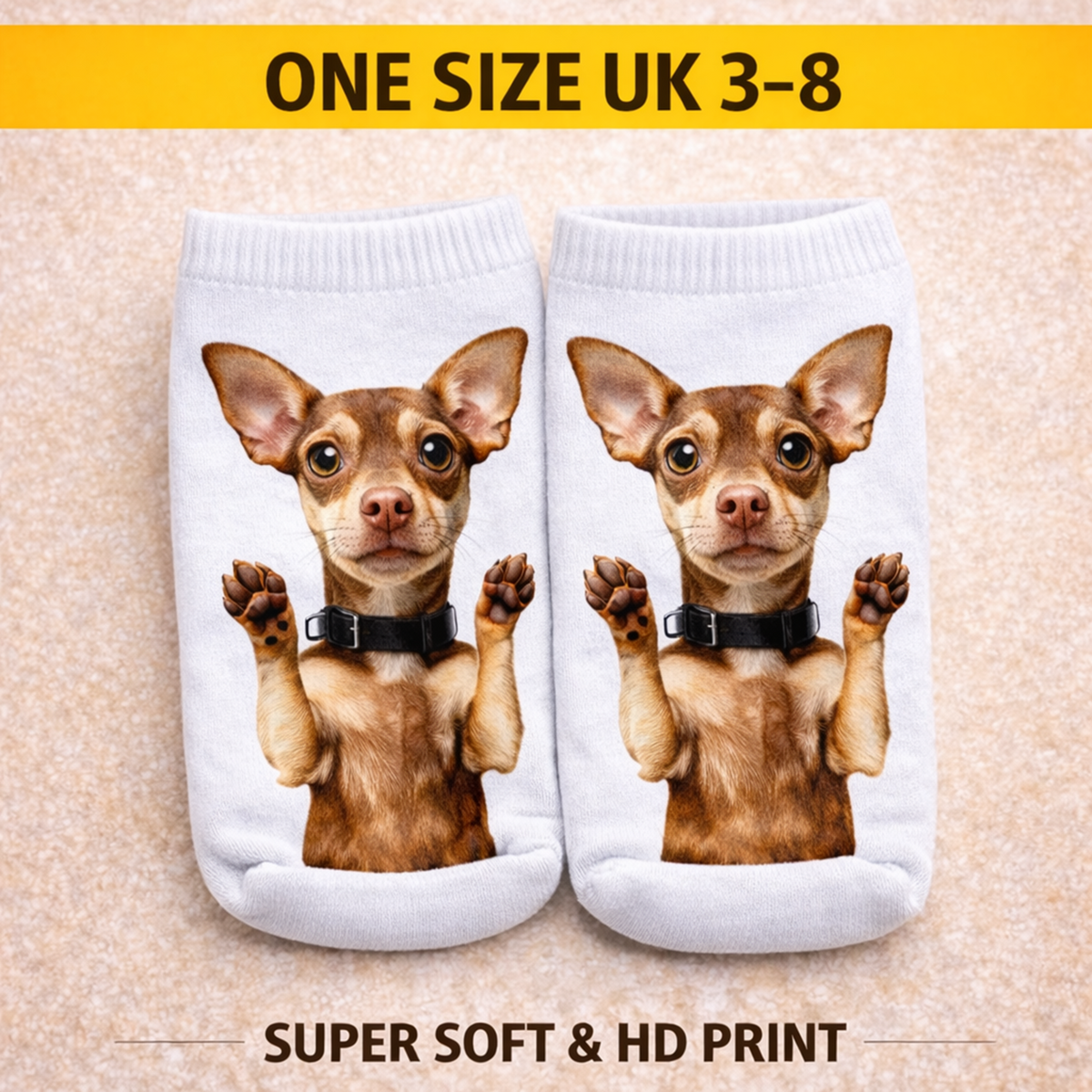 A pair of white ankle socks with a printed graphic of a small brown Chihuahua dog wearing a black collar, shown on a beige textured background with promotional text banners at the top and bottom.
