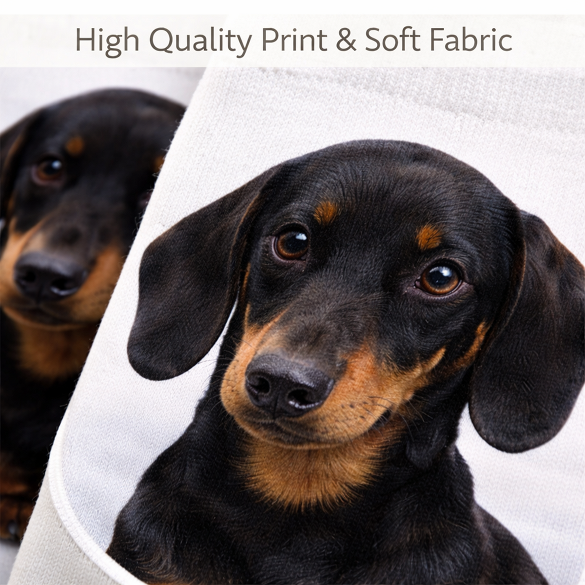 A close-up of a printed fabric featuring a black and tan dachshund dog portrait, with a folded white fabric edge visible and the text 'High Quality Print & Soft Fabric' at the top.