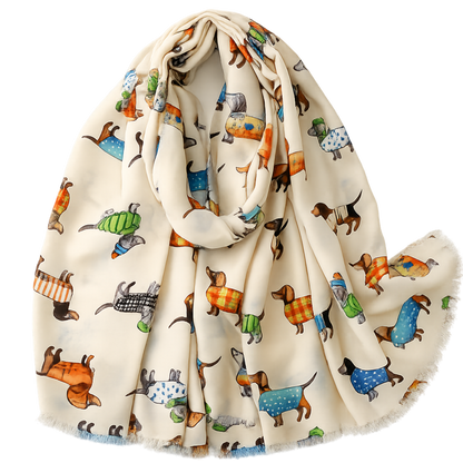 A cream-colored scarf with a playful print of dachshunds wearing colorful sweaters, shown draped on a clean white background.