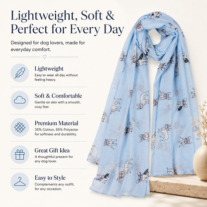 A light blue French Bulldog dog-print scarf draped over a mannequin torso on a beige surface, with marketing text and icons on the left highlighting its lightweight, soft, and comfortable qualities.